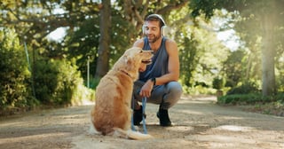 Man exercising outdoors with his dog in a park